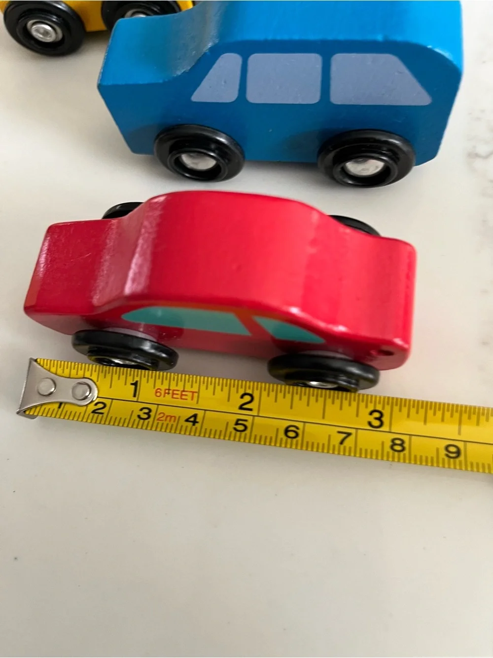 8 wooden cars and trucks.  Four are kidKraft.